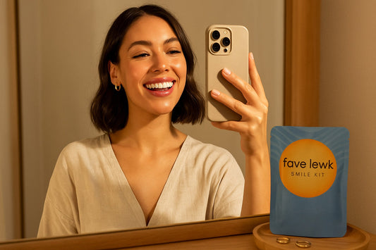 Woman smiling confidently while taking a selfie after using the Fave Lewk Smile Kit during her glow routine
