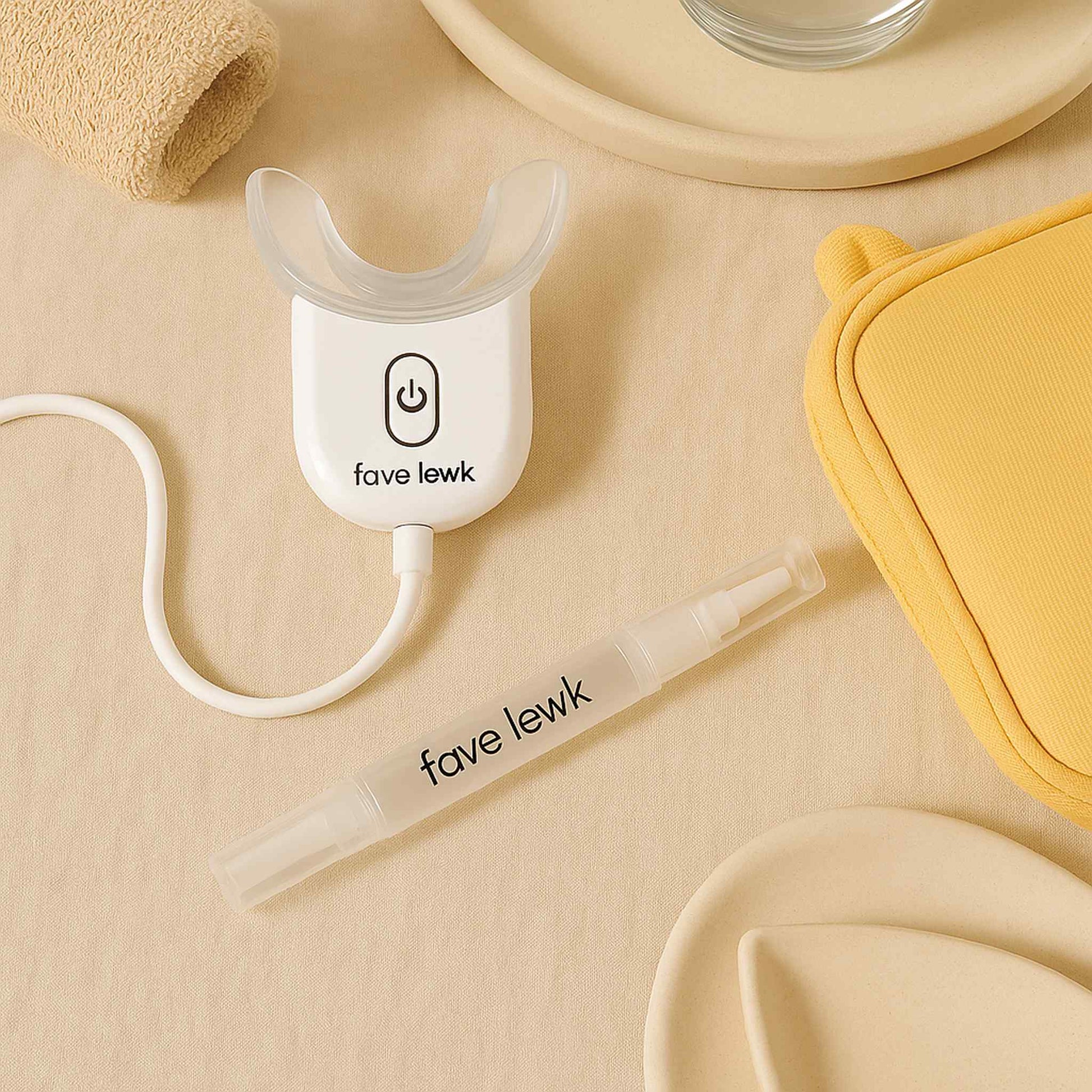 Flat lay of Fave Lewk LED Smile Kit for at-home teeth whitening with mouth tray and whitening pen